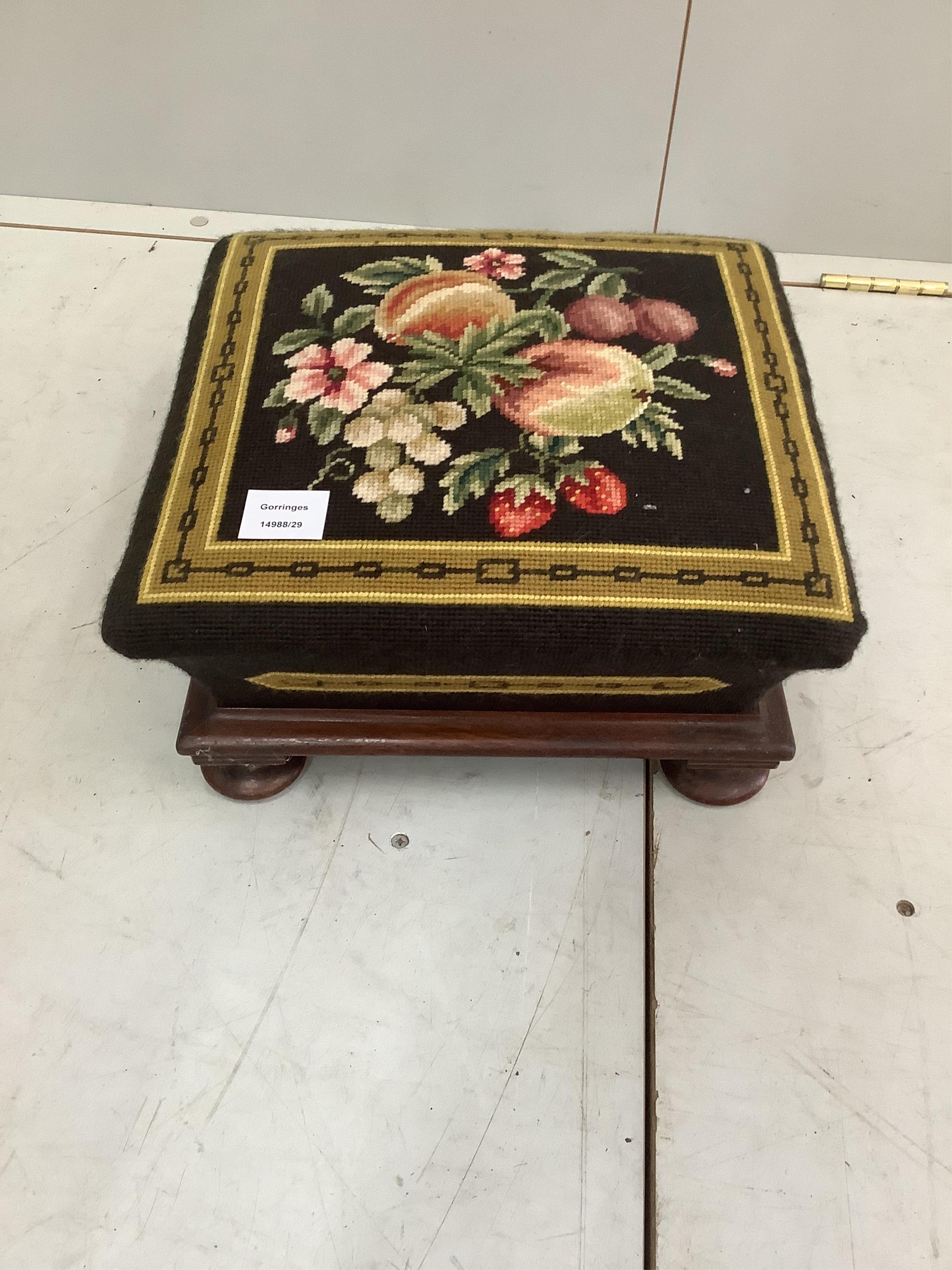A Victorian mahogany square footstool with a floral tapestry top, 36cm, height 17cm. Condition - good